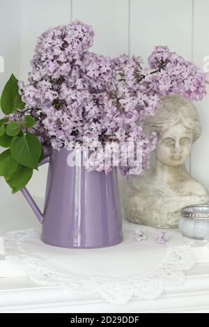 spring decoration with bouquet of lilac and woman bust Stock Photo