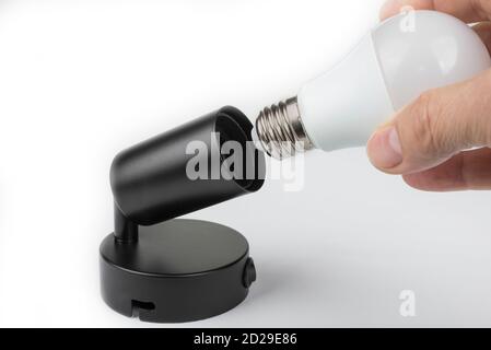 Screw in led bulb into the lamp Stock Photo