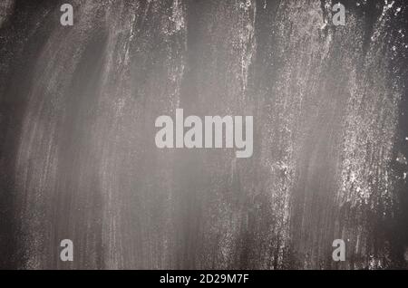 black graphite background with finely scattered flour Stock Photo