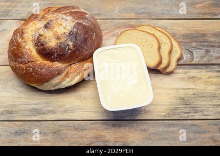 Three pieces of loaf, bread, butter on a wooden background, top view Stock Photo