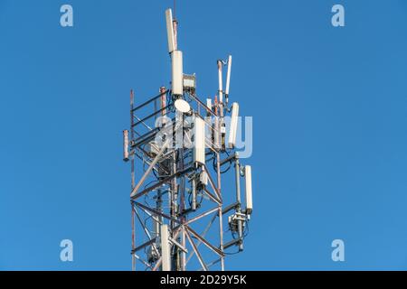 Mobile communication tower close-up against the blue sky Stock Photo