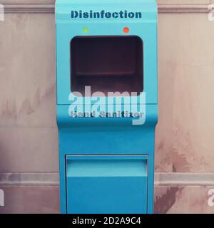 Hand sanitizer in the subway, disinfection of passengers in public transport. Blue automatic machine for hand hygiene Stock Photo