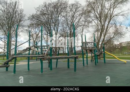 Outdoor sports ground. Ppassage of the wall obstacles. Children's play complex on an open sports field in early spring Stock Photo