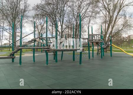 Outdoor sports ground. Ppassage of the wall obstacles. Children's play complex on an open sports field in early spring Stock Photo