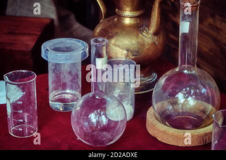 Flasks, jars and bottles for chemicals in the old laboratory. Experiments with reagent chemist, retro. Stock Photo