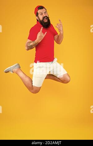 Inspired concept. Always in motion. Enjoying active lifestyle. Happy guy jumping. Active bearded man in motion yellow background. Active and energetic hipster. Energy charge. Healthy guy feeling good. Stock Photo