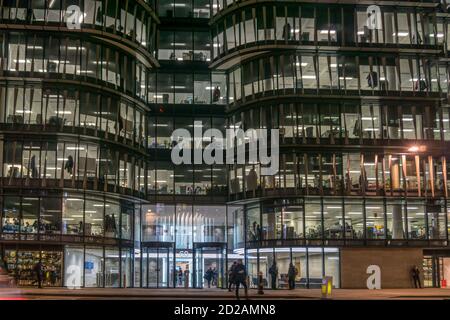 Offices and office workers at night at 60 Holborn Viaduct. Contains London HQ of Amazon. Stock Photo