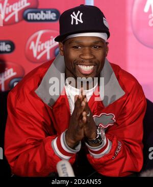 Rapper 50 Cent From The U S Holds Up A Condom During A Media Briefing At Lanseria Airport Outside Johannesburg April 30 08 50 Cent Together With His G Unit Crew Will Perform Twice