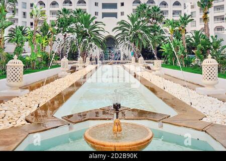View of arabic hotel. Fountain in front of the hotel and the inscription Tunisia, Sousse Stock Photo