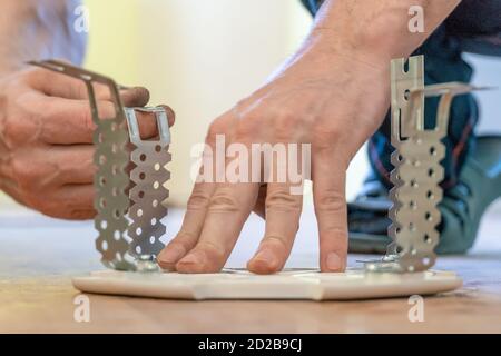Preparing the platform for a lamp for a stretch ceiling close-up Stock Photo