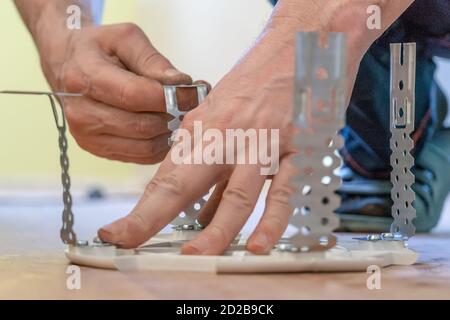 Preparing the platform for a lamp for a stretch ceiling close-up Stock Photo