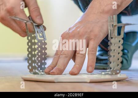 Preparing the platform for a lamp for a stretch ceiling close-up Stock Photo