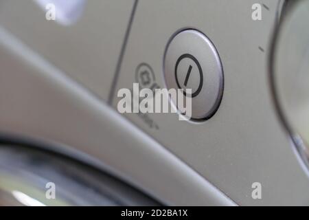 Close-up of the grey washing machine on, off button Stock Photo