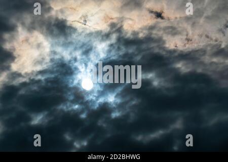 Sky with dark clouds and sun, beautiful background Stock Photo