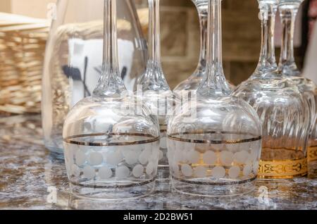 Inverted glasses on the table close-up, in the background wicker basket Stock Photo