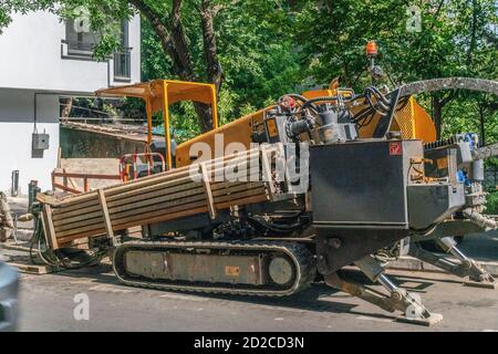 close excavator tracks on the construction site on the road, pipes. working equipment with tracks Stock Photo