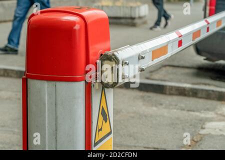 automatic red-white barrier in the yard close-up during daylight hours Stock Photo