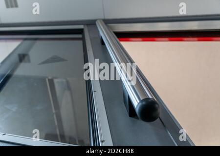 Metal handle in the elevator in order to hold on to it. Open the elevator door with mso glass Stock Photo