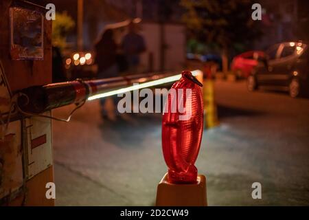 automatic red and white barrier glows in the yard close up at night Stock Photo