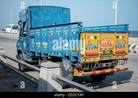 Chennai, India - February 8, 2020: A blue and yellow colorful truck parked by the beach on February 8, 2020 in Chennai, India Stock Photo