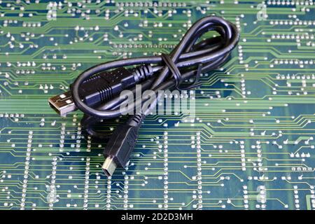 Usb cable wire against electronic circuit board Stock Photo