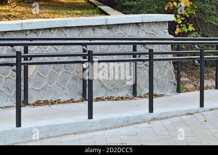Ramp for wheelchair entry with metal handrails close-up Stock Photo