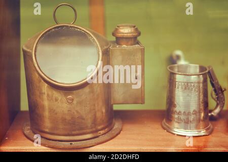 Old ship deck lamp and metal mug, close-up Stock Photo