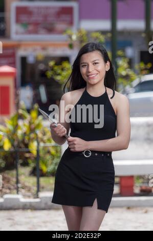 Young Latin businesswoman smiling with a tablet in her hands Stock Photo
