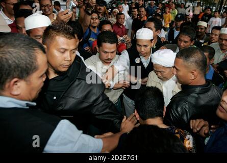 Supporters of Parti Islam SeMalaysia (PAS) celebrate in front of 