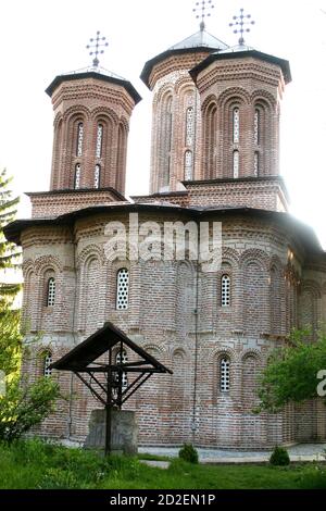 Snagov Monastery, Ilfov County, Romania. Exterior view of the 15th century Christian Orthodox church, with a simple water well beside it. Stock Photo