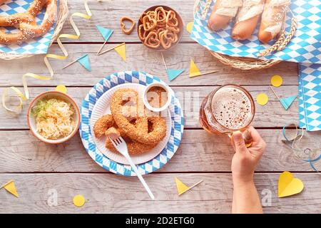 Oktoberfest, celebrating alone. Traditional food, beer, top view on wooden table, ce Stock Photo