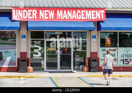 Florida,Sebring,Sunoco,petrol gas station,convenience store,under new management,entrance exterior,man men male adult adults,visitors travel traveling Stock Photo