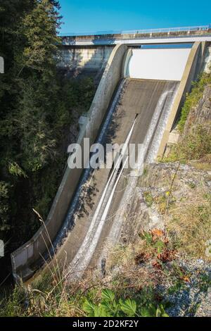 Cleveland Dam by Capilano Lake in North Vancouver, BC. Vertical view on the high dam with flowing water. Stock Photo