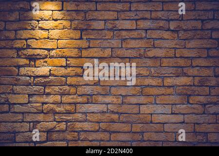 Light brick wall with lighting. Wall of brown color Stock Photo