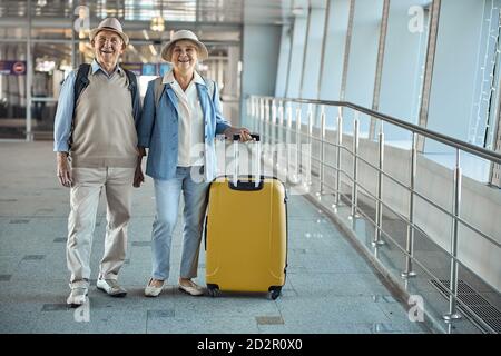 Joyous tourist couple standing at the airport Stock Photo