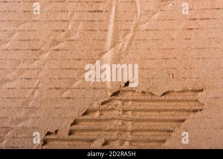 Top view of torn edges corrugated brown cardboard sheet of paper texture or background flat lay, Folded recycle carton paper box Stock Photo