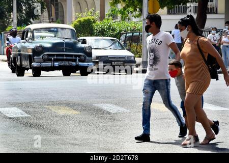 Havana, Cuba. 5th Oct, 2020. People wearing face masks walk on a street in Havana, Cuba, Oct. 5, 2020. Credit: Joaquin Hernandez/Xinhua/Alamy Live News Stock Photo