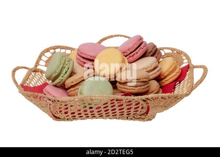 Macaron isolated. Close-up of colourful French macaroons in a basket on red napkin isolated on a white background. Pastries, desserts and sweets. Macr Stock Photo