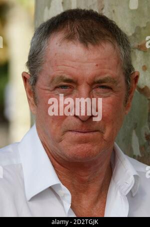 British actor John Nettles poses with a beer during a photo call in