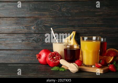 Glasses and jars with different juices on wooden background Stock Photo