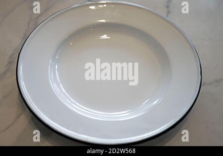 Close up White zinc and tin plate on marble table Stock Photo
