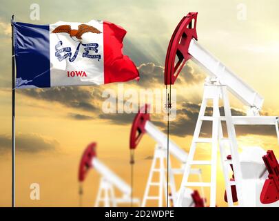 Oil rigs against the backdrop of the colorful sky and a flagpole with the flag State of Iowa. The concept of oil production, minerals, development of Stock Photo
