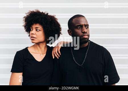 Black cool couple posing over white background looking at camera Stock Photo