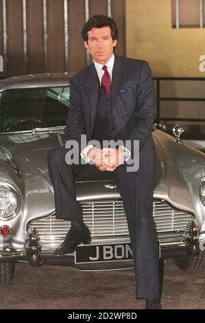 PAP 5 22.1.95. LEAVESDEN. Irish-born actor Pierce Brosnan, who is to play the legendary Commander James Bond of the British Secret Service, poses with the Aston Martin car made famous by Sean Connery who played the role in the film 'Goldfinger', during a photocall at Leavesden Airfield, Herts, today (Sunday). Christmas 1995 is the projected world-wide release date for the new Bond film "Goldeneye". See PA story SHOWBIZ Bond. PA News, Stefan Rousseau. /PJ. Stock Photo