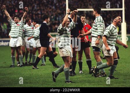 The Cambridge team celebrate after claiming the Bowring Bowl when they beat Oxford in the Varsity Match at Twickenham today (Tuesday). See PA Story Rugby Varsity. Stock Photo