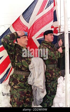 The Union Flag is raised to mark the transfer of authority from the UN to NATO in Bosnia. Pictured are: (Left) Warrant Officer 2 Michael Stacey from Edinburgh and Warrant Officer 2 James Hill from Oldham, both soldiers from the 1st Battalion The Royal Regiment of Fusiliers./ By Lcpl Darren Cooper MPC/LAND Stock Photo