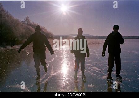 Ice skaters on the Lake of Menteith, near Aberfoyle, in Scotland today (Thursday). The last time the 'Bonspiel', a local curling tournament, took place on the lake was in 1979. The lake is over 1.5 miles long and 1 mile wide. Stock Photo