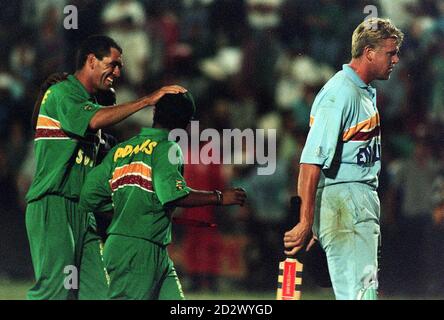 South African captain Hansie Cronje gives Paul Adams a pat on the head as they and England's Peter Martin leave the field, at the end of the 6th one day international at Buffalo Park, East London. Stock Photo