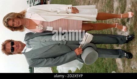 Pop superstar Rod Stewart and his wife, model Rachel Hunter, arrive Satrurday at Epsom Racecourse for the traditional Derby Day meeting. The Queen and Duke of Edinburgh were amongst racegoers - many of whom appeared to have stayed at home to watch the opening round of the European football championships. Stock Photo