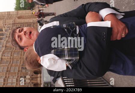 Three-year-old Jack Crozier, whose sister Emma was one of the Dunblane massacre victims, shys away from cameras as his father (unnamed) cradles him, at the House of Commons today (Wed), where bereaved parents and relatives handed over a 700,000 signature petition calling for a ban on private ownership of handguns, tougher certification for all guns, and for recreational guns to be kept securely at authorised clubs with the firing mechanism removed. See PA Story ROYAL Dunblane. Photo by Stefan Rousseau. Stock Photo